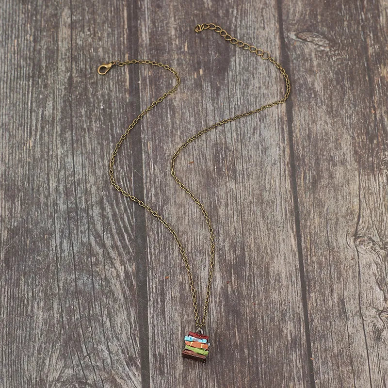 Stacked prism charm necklace with multicolor stacked charm and antique brass chain.