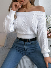 White cable knit off-shoulder crop sweater with diamond pattern and balloon sleeves.
