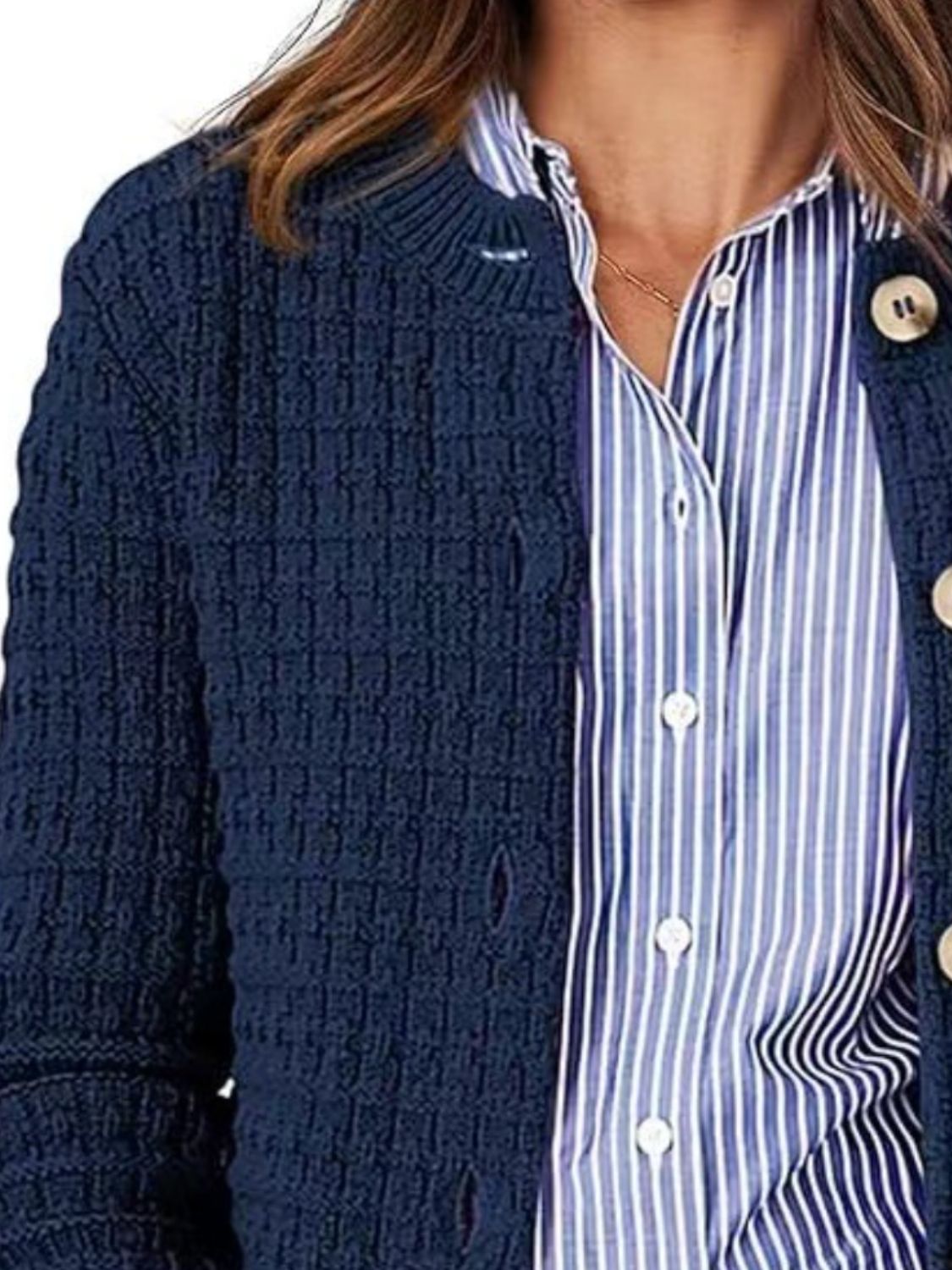 Navy textured knit button-up cardigan with cream buttons, styled over a blue striped shirt.