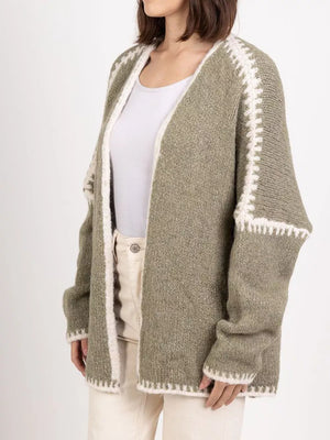 Sage oversized cardigan with contrast white trim and stitching detail.