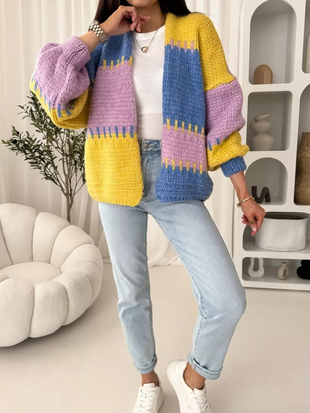 Pastel colorblock cardigan with balloon sleeves and open front, styled with jeans.