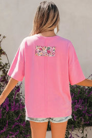 Pink cotton oversized tunic t-shirt with floral patch detail on back.