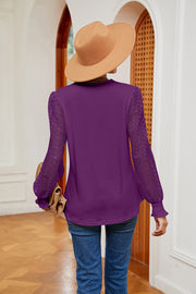 Purple knit v-neck blouse with lace sleeves and ruffled cuffs.