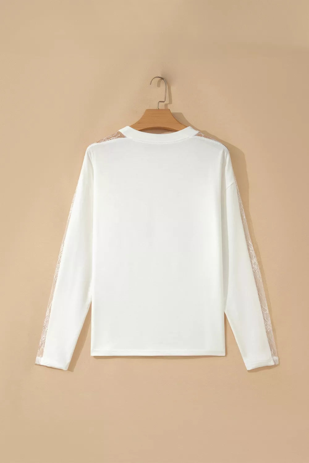 White long sleeve crew neck shirt with delicate lace details on the sleeves.