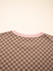 Chic checkerboard loungewear pullover with pink trim.