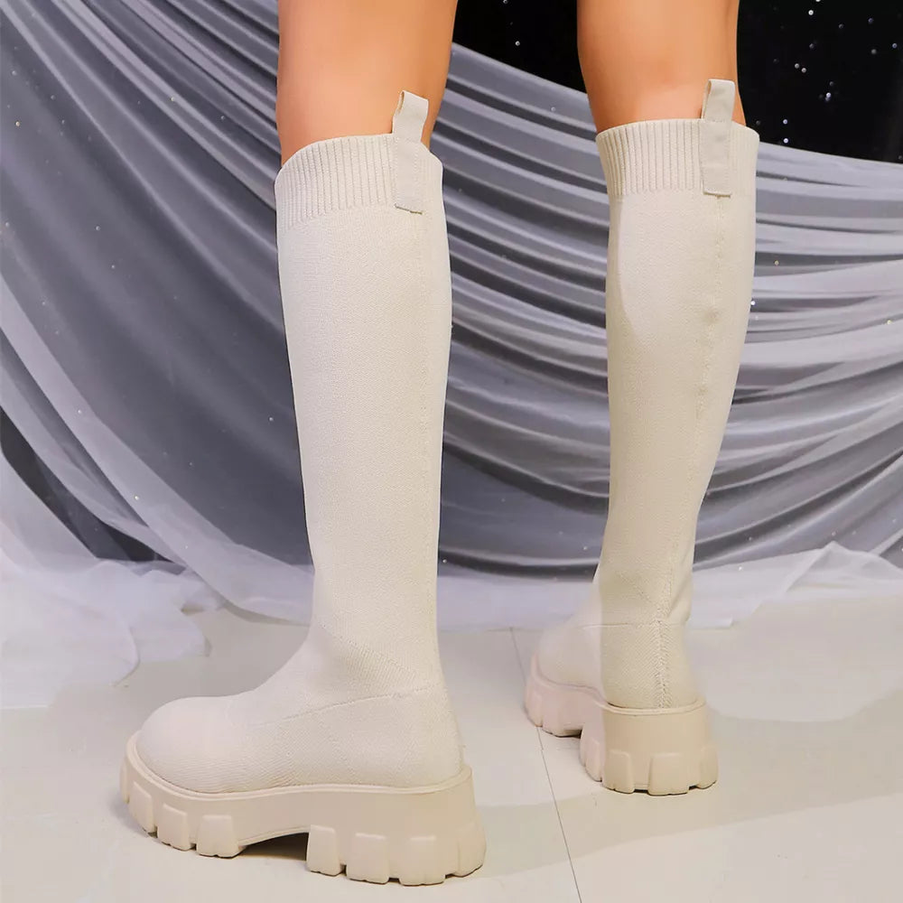 Off-white knit knee-high boots with chunky platform soles and pull tabs.