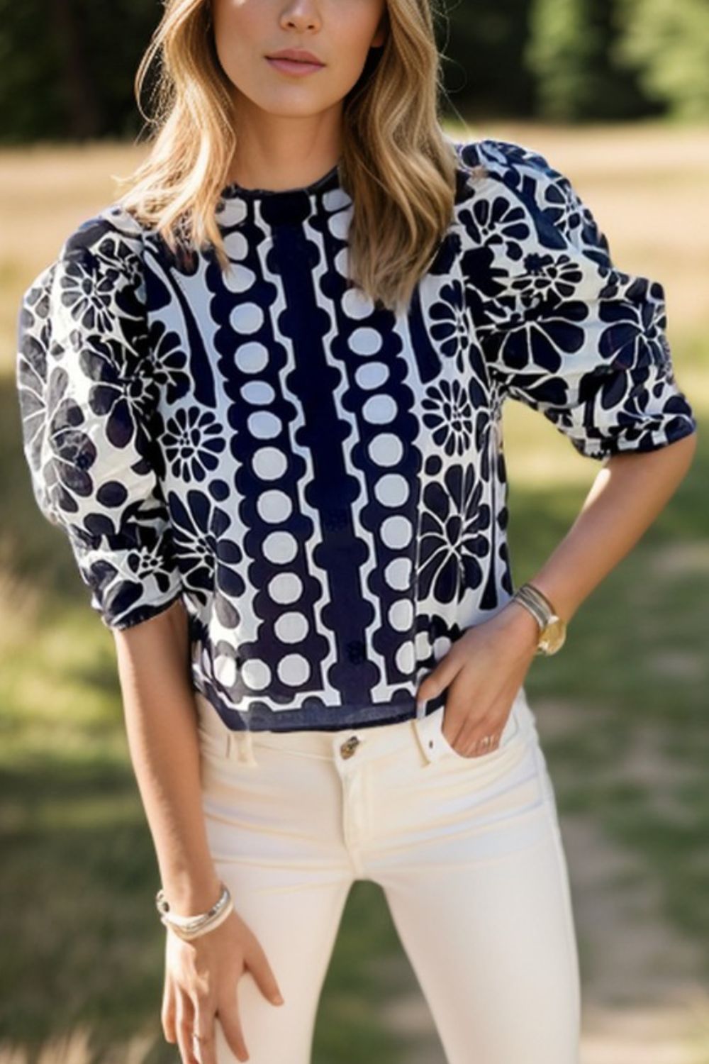 Black floral puff sleeve blouse with button back and high neckline.