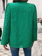 Dark green eyelet embroidered blouse with ruffle collar and long sleeves.