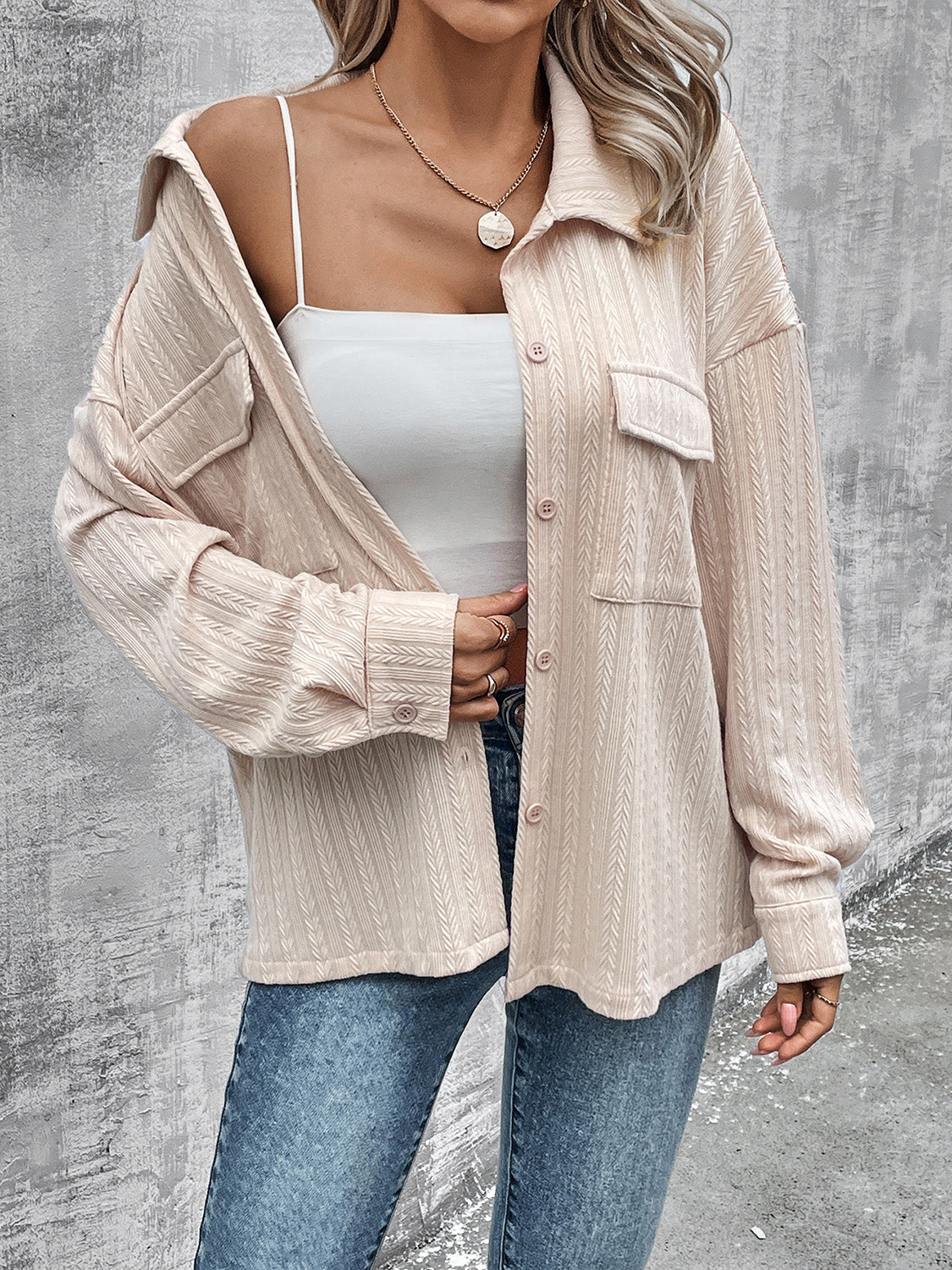 Beige textured overshirt with relaxed fit, button front, and chest pockets.