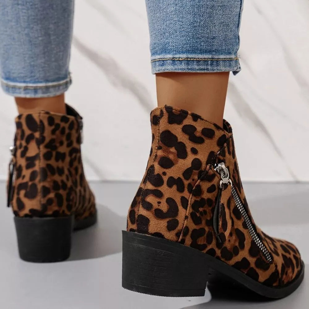 Leopard print suede ankle boots with block heels and side zippers.