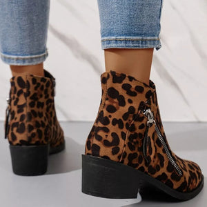 Leopard print suede ankle boots with block heels and side zippers.