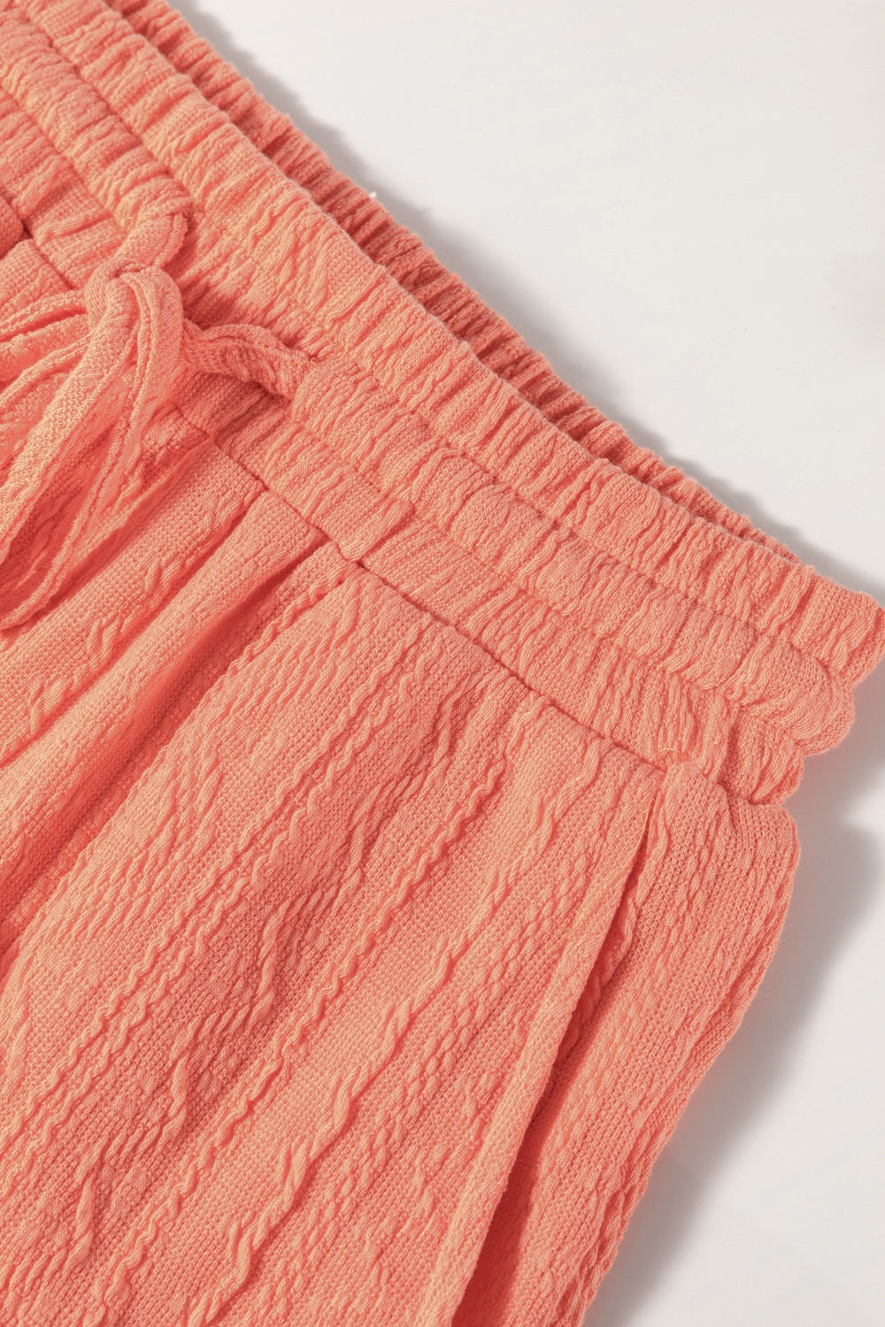 Textured knit drawstring shorts in sherbet with cable knit detail and elastic waistband.