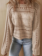 Tan cable knit jumper with cut-out details and boat neckline, worn with jeans.