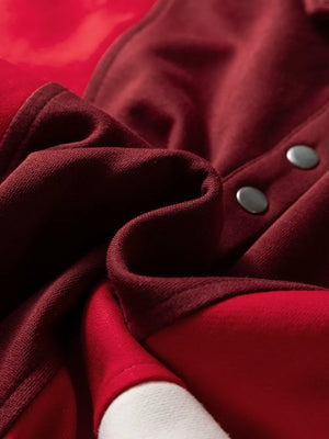 Oversized cotton hoodie with color block design in red and burgundy, featuring snap buttons.