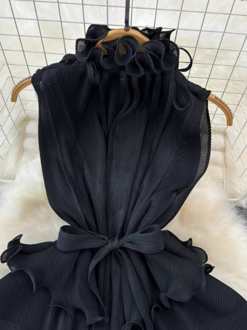Black ruffled tiered midi dress with belted waist and frill details.