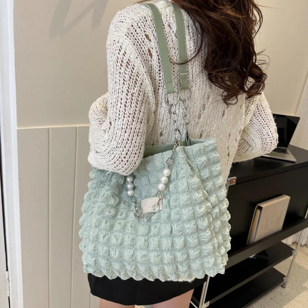Light green textured grid pearl chain tote bag with a casual shopper style.