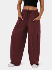 Burgundy maternity pants with adjustable drawstring waist and wide legs.