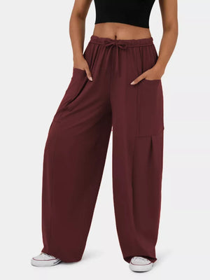 Burgundy maternity pants with adjustable drawstring waist and wide legs.