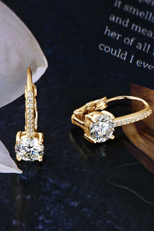Gold leverback earrings with pavé-set moissanite and a large center stone.