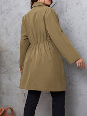 Trench coat in mocha with gathered waistline and roll-tab sleeves.