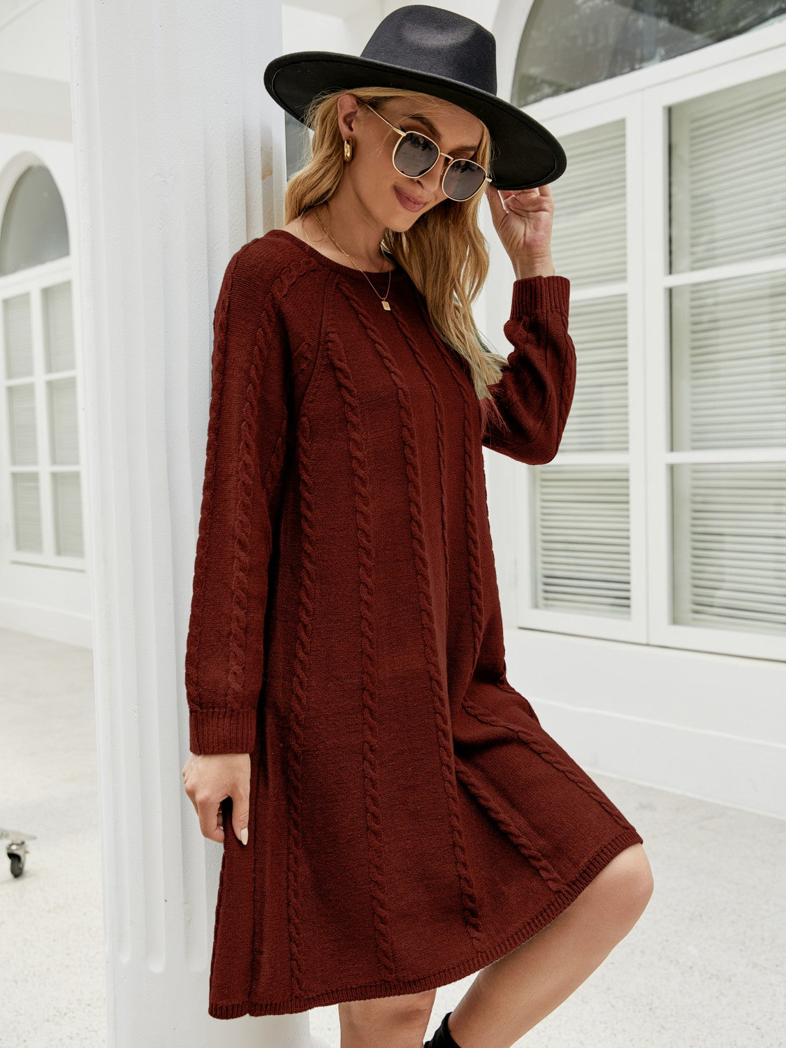 Wine cable knit A-line sweater dress with crew neck and long sleeves.