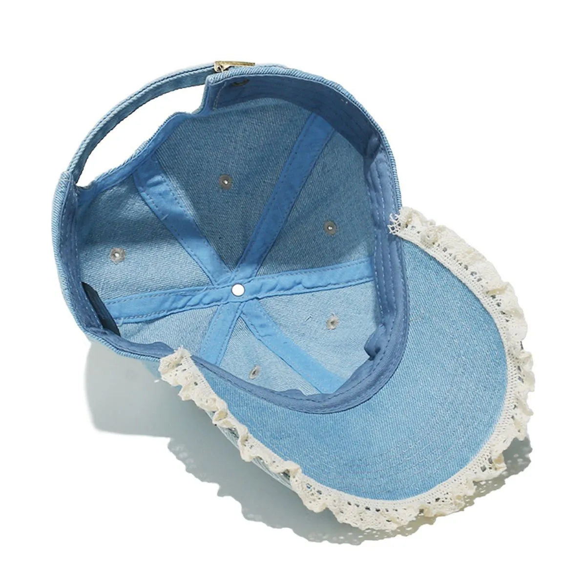 Light blue denim baseball cap with lace trim and adjustable strap.