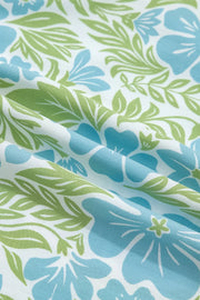 Charming floral mini dress fabric with blue flowers and green leaves on white.