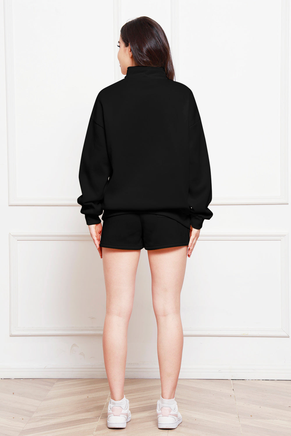 Black quarter-zip loungewear set with shorts and a mock neck sweatshirt.