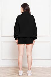 Black quarter-zip loungewear set with shorts and a mock neck sweatshirt.