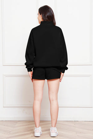 Black quarter-zip loungewear set with shorts and a mock neck sweatshirt.