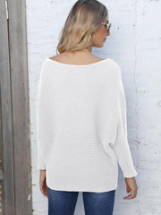 White ribbed dolman knit sweater with off-the-shoulder neckline and long sleeves.