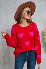 Red acrylic knit sweater with pink intarsia hearts, crew neck, long sleeves.