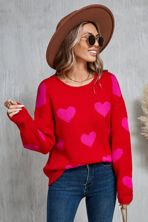 Red acrylic knit sweater with pink intarsia hearts, crew neck, long sleeves.
