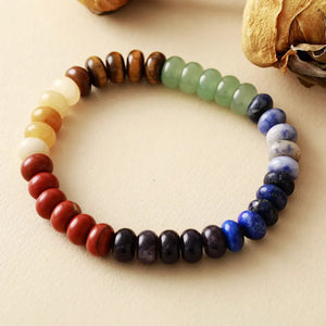 Chakra stone bead bracelet with rainbow colored natural stones and wooden beads.