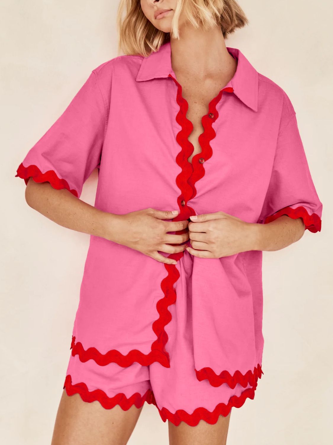 Hot pink shirt and shorts set with red scallop trim and short sleeves.