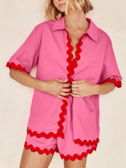 Hot pink shirt and shorts set with red scallop trim and short sleeves.