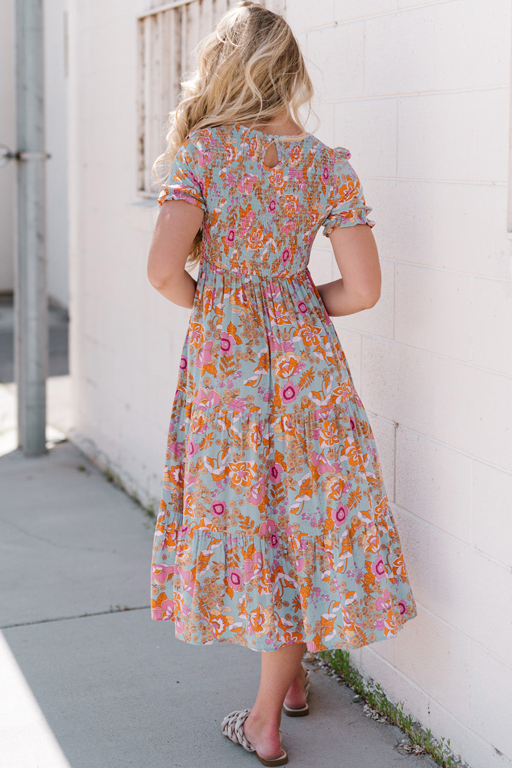 Floral smocked bodice tiered midi dress with short flutter sleeves and keyhole back.