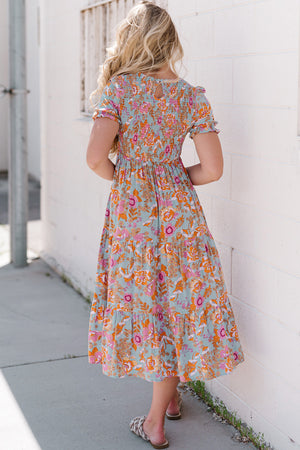 Floral smocked bodice tiered midi dress with short flutter sleeves and keyhole back.