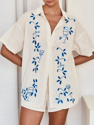 Cream linen co-ord set with blue floral embroidery and ciao text detail.