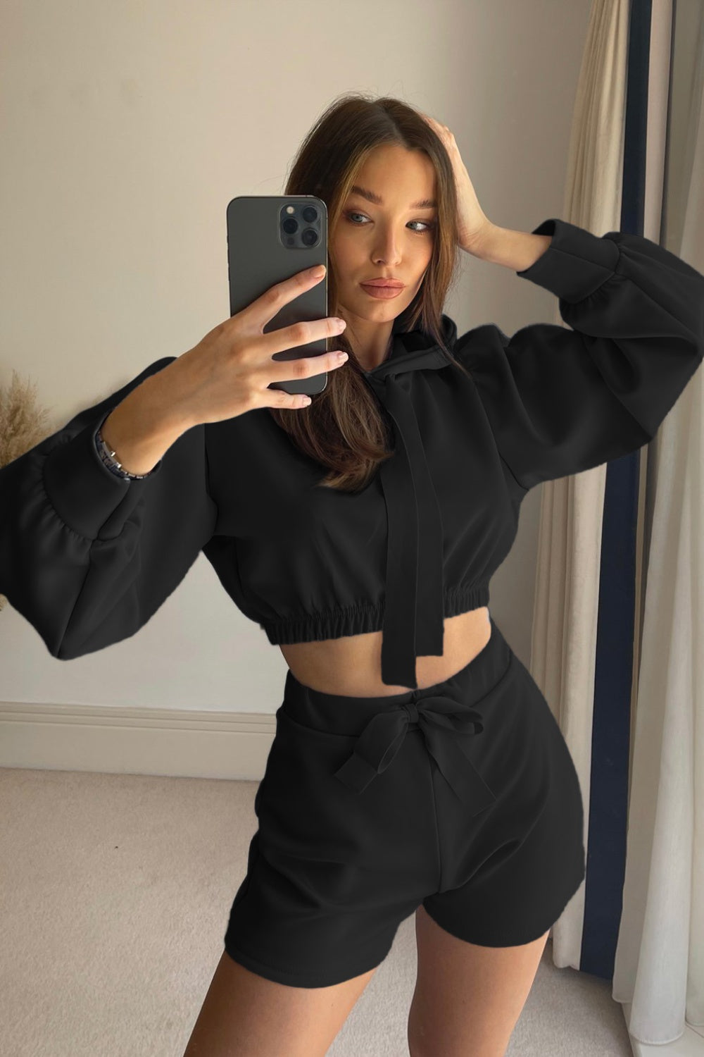 Black cropped hoodie with tie detail and matching shorts with bow detail