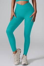 Teal ribbed contour leggings with V-waist and seam details.