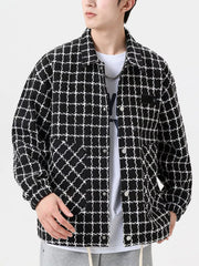 Oversized black and white plaid button-up jacket with textured fabric and chest pocket.