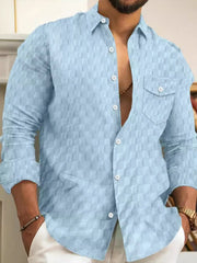 Light blue textured cotton button-up shirt with a checkered pattern and two chest pockets.