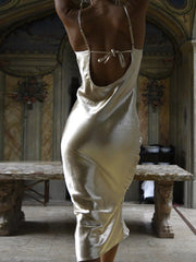 Gold cowl neck midi dress with tied back detail and body-skimming fit.