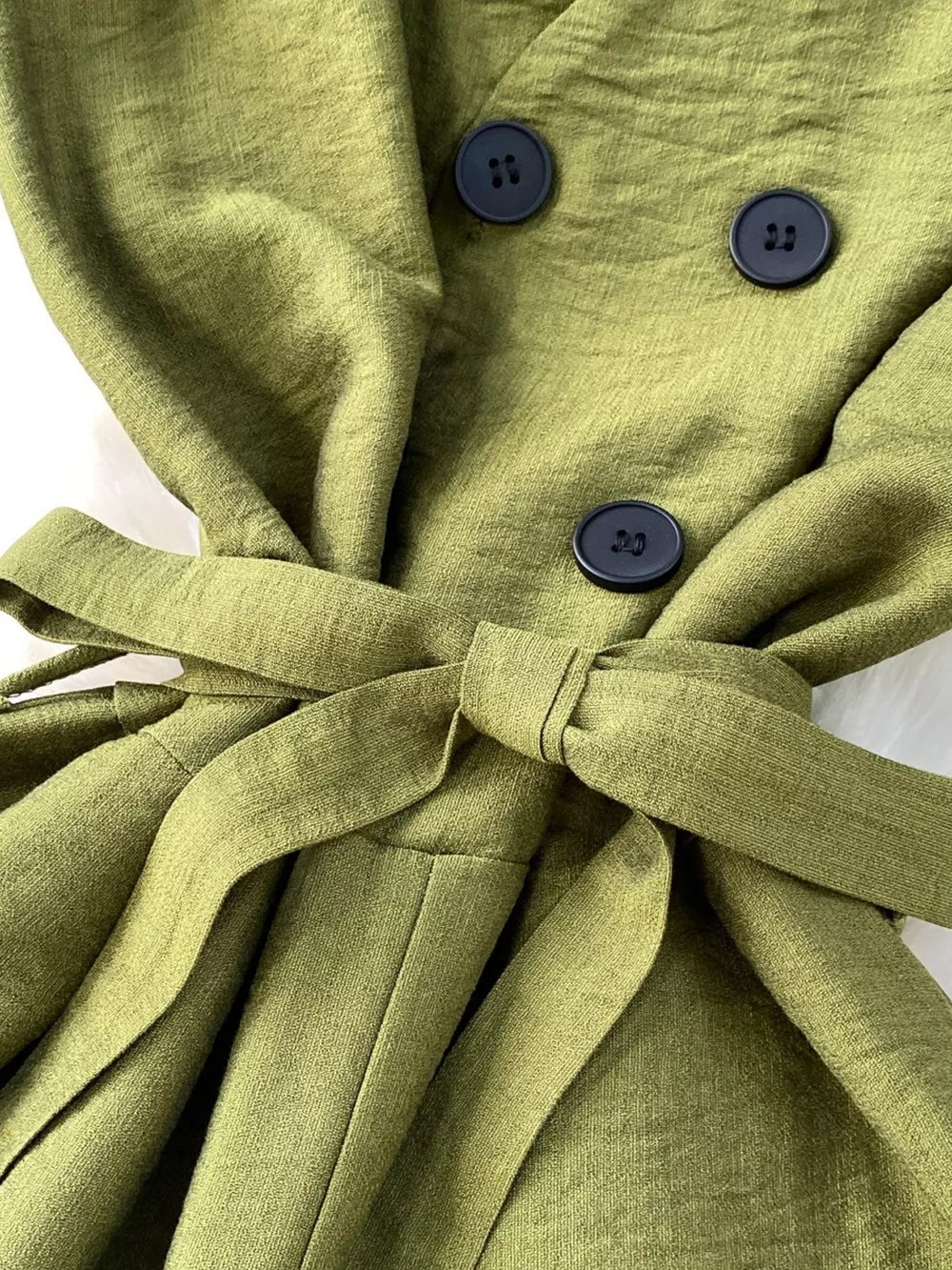 Green V-neck wide leg jumpsuit with tie belt and button detail