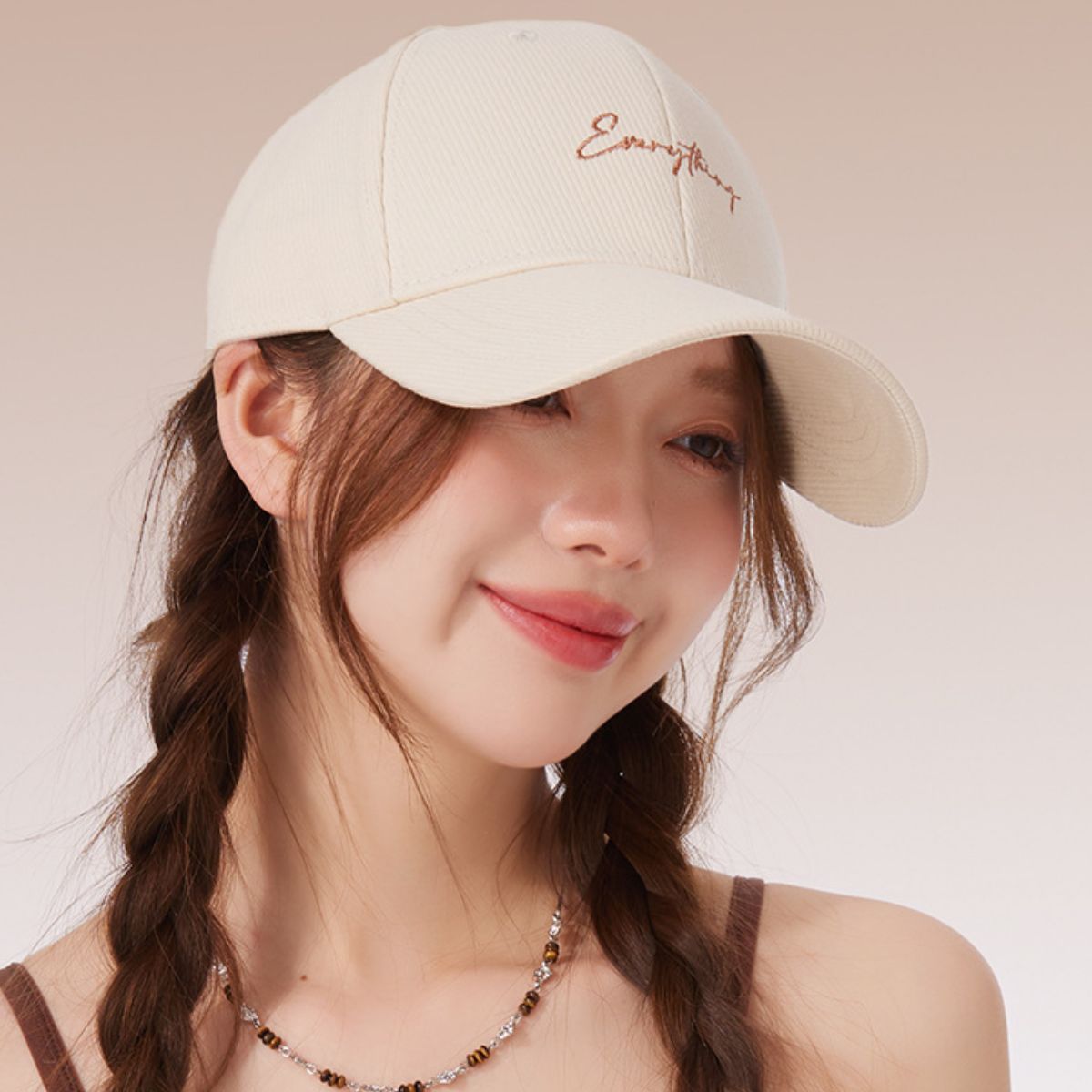 Rice white cotton baseball cap with cursive embroidery and curved brim.