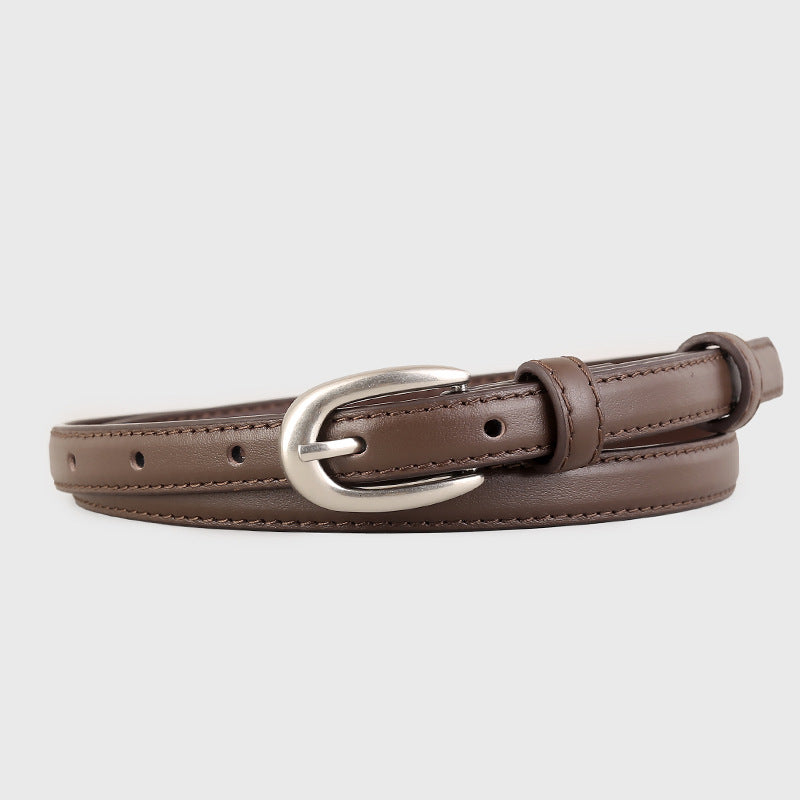 Brown leather skinny belt with silver buckle and classic stitching.