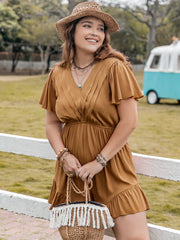 Caramel pleated bodice romper with flutter sleeves and ruffle hem.