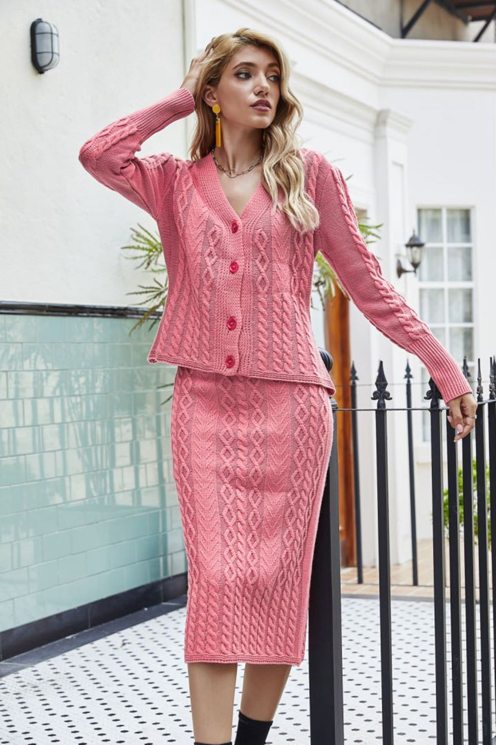 Pink cable knit cardigan and pencil skirt set with V-neck and button front.