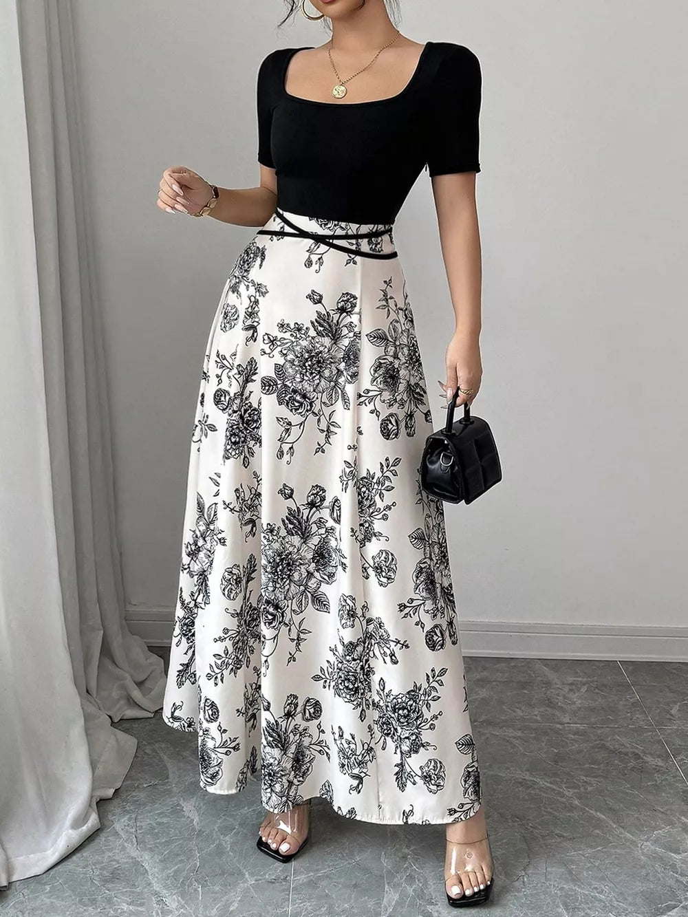 Chic floral maxi dress with square neckline, black top, white skirt with black floral print.